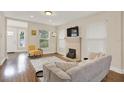 Bright living room featuring hardwood floors and a fireplace at 1214 E Curtis St, Tampa, FL 33603