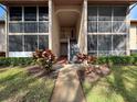Condo building entryway with stairs and plants at 12218 Fox Chase Dr # G2, Hudson, FL 34669