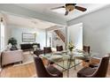 Bright dining room with a glass table and chairs, adjacent to the living room at 12833 Darby Ridge Dr, Tampa, FL 33624