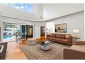 Living room with hardwood floors, leather sofas, and views of the backyard pool at 12833 Darby Ridge Dr, Tampa, FL 33624