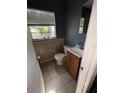 Small bathroom with a toilet, sink, and shower at 1357 Terrace Rd, Clearwater, FL 33755