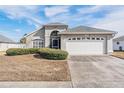 One-story house with attached garage and neatly landscaped front yard at 13910 Pimberton Dr, Hudson, FL 34669