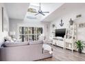 Bright living room with gray sectional sofa and coastal decor at 1398 Shady Pine Way # E3, Tarpon Springs, FL 34688