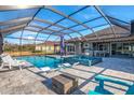 Inviting pool area with covered patio and lounge chairs at 14214 Quintessa Ln, Lithia, FL 33547