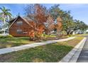 Side view of the house with wood siding and landscaping at 1455 Briarwood Ct, Safety Harbor, FL 34695