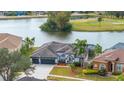 House by the lake with golf course views and a three-car garage at 15910 Muirfield Dr, Odessa, FL 33556