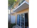 Sliding glass doors leading to a small patio and fenced backyard at 2566 Sea Wind Way, Clearwater, FL 33763