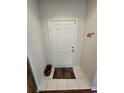 Front entry with door, basket, and small rug at 30119 Wellesley Way, Wesley Chapel, FL 33543