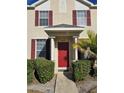 Townhome entrance with red door and red shutters at 30119 Wellesley Way, Wesley Chapel, FL 33543