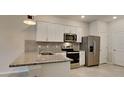 Modern kitchen with stainless steel appliances and granite countertops at 31424 Amberview Bend, Wesley Chapel, FL 33545