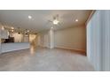 Spacious living room with tile floors and a ceiling fan at 31424 Amberview Bend, Wesley Chapel, FL 33545