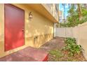 Small backyard with a red door and small plants at 3314 Las Campos Pl, Tampa, FL 33611