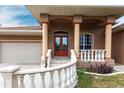 Elegant entryway with double doors, a tiled porch, and ornate columns at 3391 Knox Ter, Port Charlotte, FL 33948