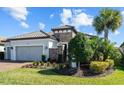 Charming home exterior with a brick accent wall, well-kept lawn, and beautiful landscaping at 3404 Forsythia Dr, Odessa, FL 33556