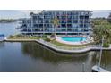 Condo building exterior showcasing balcony and waterfront location at 4823 Ebbtide Ln # 403, Port Richey, FL 34668