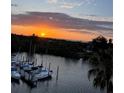 Stunning sunset view over marina, boats and water at 4823 Ebbtide Ln # 403, Port Richey, FL 34668