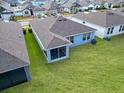 The home's backyard provides ample space for relaxation and recreation at 711 Old Windsor Way, Spring Hill, FL 34609