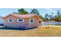 Side view of the house showcasing the brick exterior and landscaping at 7499 7Th N St, St Petersburg, FL 33702