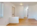 Bright living room with wood-look floors and white brick accent wall at 7499 7Th N St, St Petersburg, FL 33702