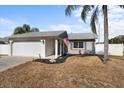 Front view of a house with a white brick facade at 7745 Deer Foot Dr, New Port Richey, FL 34653