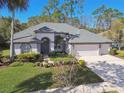 Aerial view of a single-Gathering home with a spacious driveway and well-manicured lawn at 10524 Greencrest Dr, Tampa, FL 33626