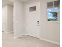 Bright entryway with tile floors and a white door at 11498 Boundless Ter, Venice, FL 34293