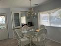 Bright dining area with glass table and white chairs at 12501 Ulmerton Rd # 64, Largo, FL 33774