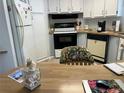 Galley kitchen with wood countertops and appliances at 12501 Ulmerton Rd # 64, Largo, FL 33774