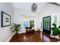 Bright and airy entryway with hardwood floors and a modern chandelier at 136 16Th Ne Ave, St Petersburg, FL 33704