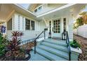 Steps leading to a light teal front door, flanked by lanterns at 136 16Th Ne Ave, St Petersburg, FL 33704