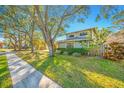 Ranch style home with gray siding and a spacious yard at 14214 Lark Ct, Clearwater, FL 33762