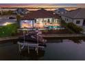 Waterfront backyard boasts a screened lanai, outdoor bar, pool, and convenient boat lift for easy access to the water at 1902 4Th E St, Palmetto, FL 34221