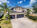 Two-story house, three-car garage, and spacious driveway at 19029 Chislehurst Dr, Land O Lakes, FL 34638