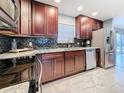 Bright kitchen with stainless steel appliances and granite countertops at 2446 Belleair Rd, Clearwater, FL 33764