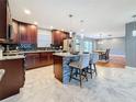 Modern kitchen with dark wood cabinets and breakfast bar at 2446 Belleair Rd, Clearwater, FL 33764