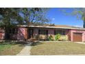 Charming single-story home with a well-maintained lawn, mature trees, and attached one car garage at 3083 55Th N Ave, St Petersburg, FL 33714