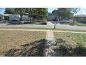 Street view of home in quiet neighborhood, highlighting landscaping and street parking at 3083 55Th N Ave, St Petersburg, FL 33714