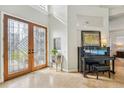 Elegant entryway with stained glass doors and piano at 363 Sanctuary Dr, Crystal Beach, FL 34681