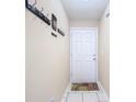 Interior entryway with tiled floor and coat hooks at 37804 Prairie Rose Loop, Zephyrhills, FL 33542