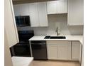 Modern kitchen with white cabinets, quartz countertops, and stainless steel appliances at 4511 S Oak Dr # R12, Tampa, FL 33611