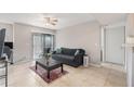 Bright living room featuring tile floors, a ceiling fan and sliding glass door to the patio at 455 Alt 19 S # 268, Palm Harbor, FL 34683