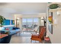 Living room with water views and mid-century modern furniture at 4900 Brittany S Dr # 909, St Petersburg, FL 33715