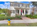 Two-story white house with black shutters, front porch, and landscaped yard at 10023 Brompton Dr, Tampa, FL 33626