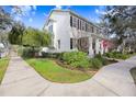 Two-story white house with black shutters, front porch, and landscaped yard at 10023 Brompton Dr, Tampa, FL 33626