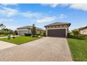 House exterior, paver driveway, landscaping at 11111 Callisia Dr, Odessa, FL 33556