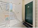 Condo building entry with green door and stairs at 1203 Bay Club Cir # 1203, Tampa, FL 33607
