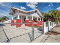 Home's exterior, side yard, and chain link fence at 1318 E Louise Ave, Tampa, FL 33603