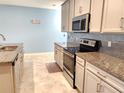 Modern kitchen with granite countertops and stainless steel appliances at 17009 Clear Cork Dr, Wimauma, FL 33598