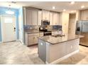 Modern kitchen featuring granite countertops, stainless steel appliances, and an island at 17009 Clear Cork Dr, Wimauma, FL 33598