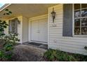 House's entrance with double doors, gray shutters, and exterior lighting at 1760 Kenesaw Ln, Clearwater, FL 33765